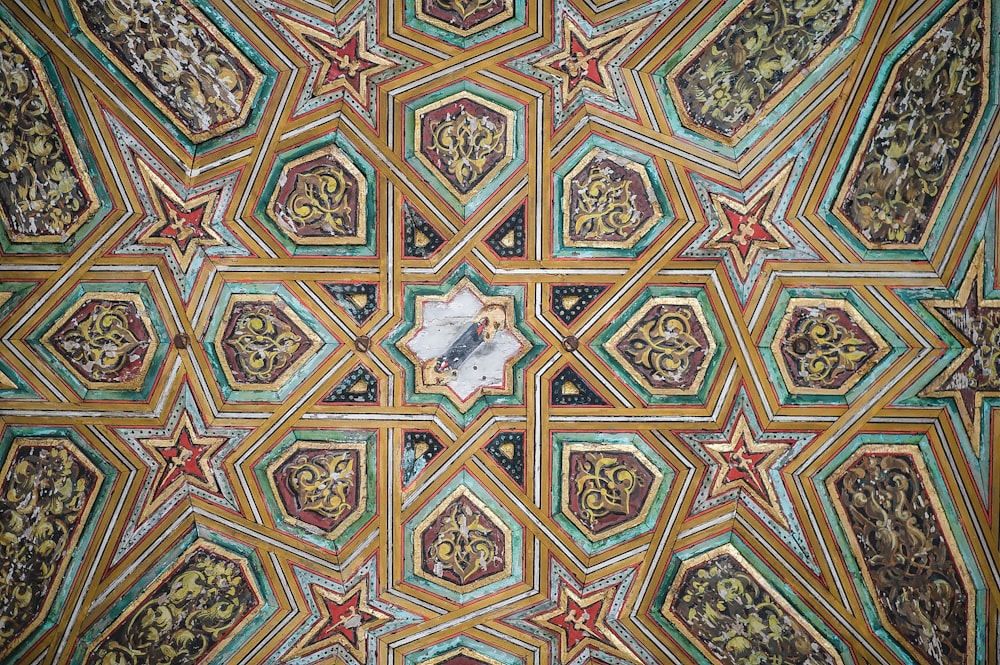 a close up of a ceiling with a clock on it