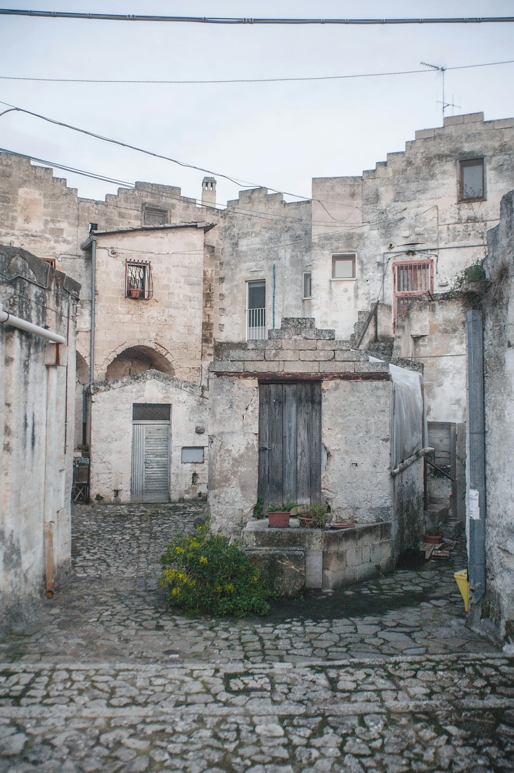 a cobblestone street with old buildings and a door