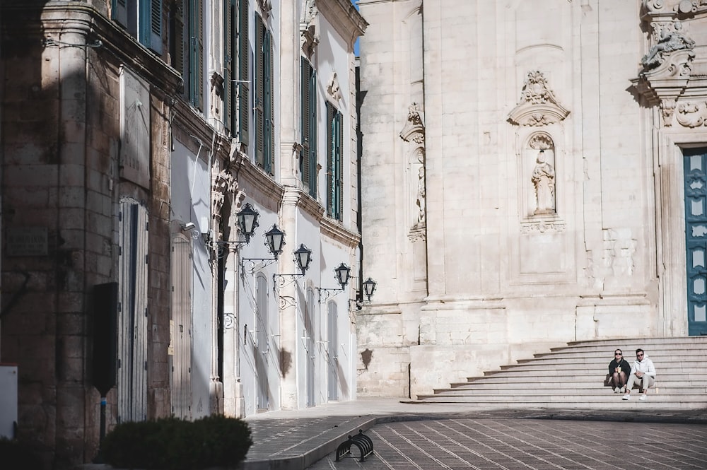 a couple of people that are standing in front of a building