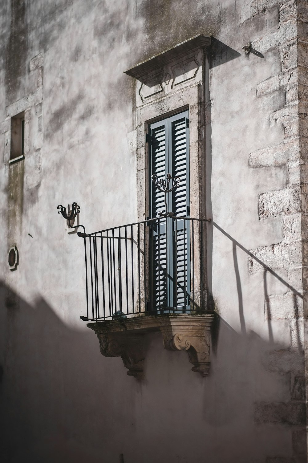 a balcony with a wrought iron railing next to a building