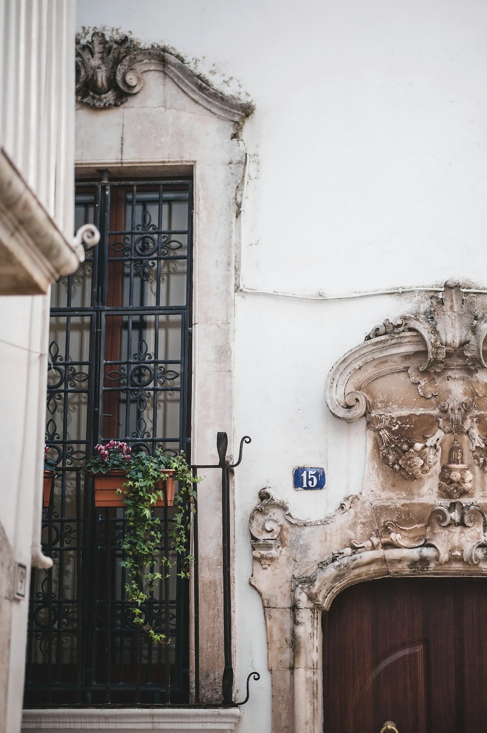 a building with a wooden door and a planter