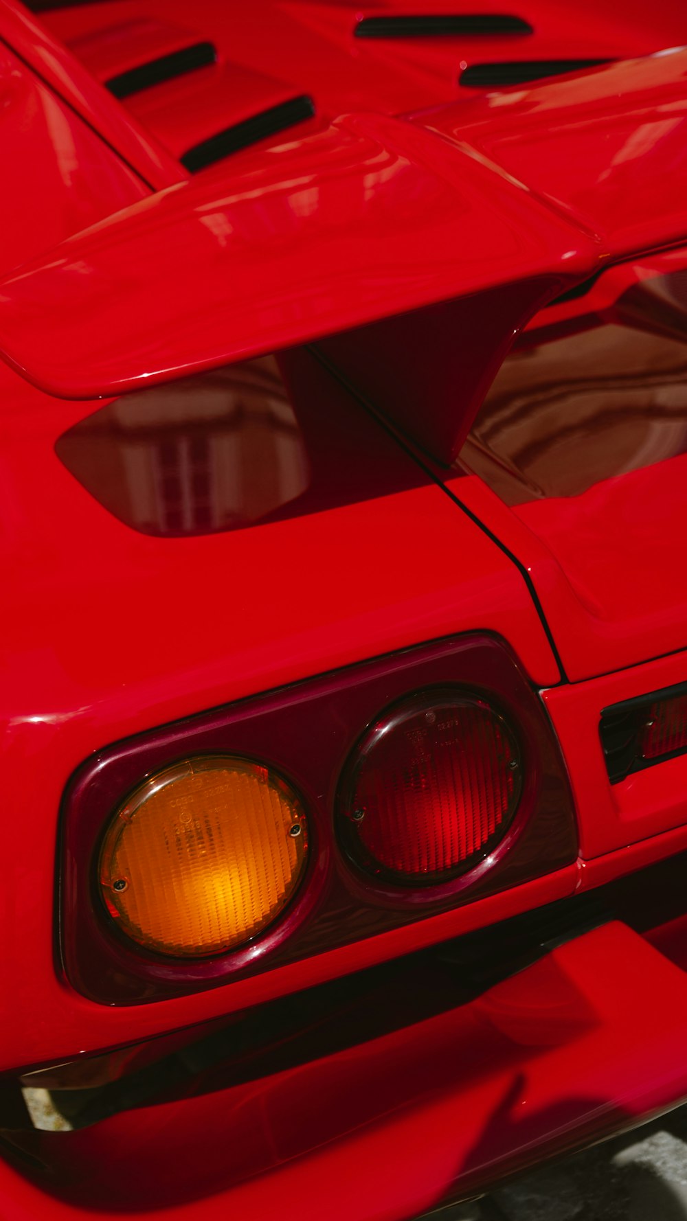 a close up of the front of a red sports car