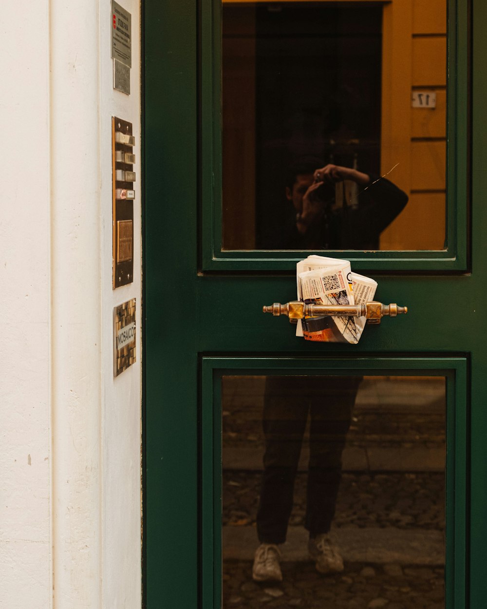 a person taking a picture through a green door