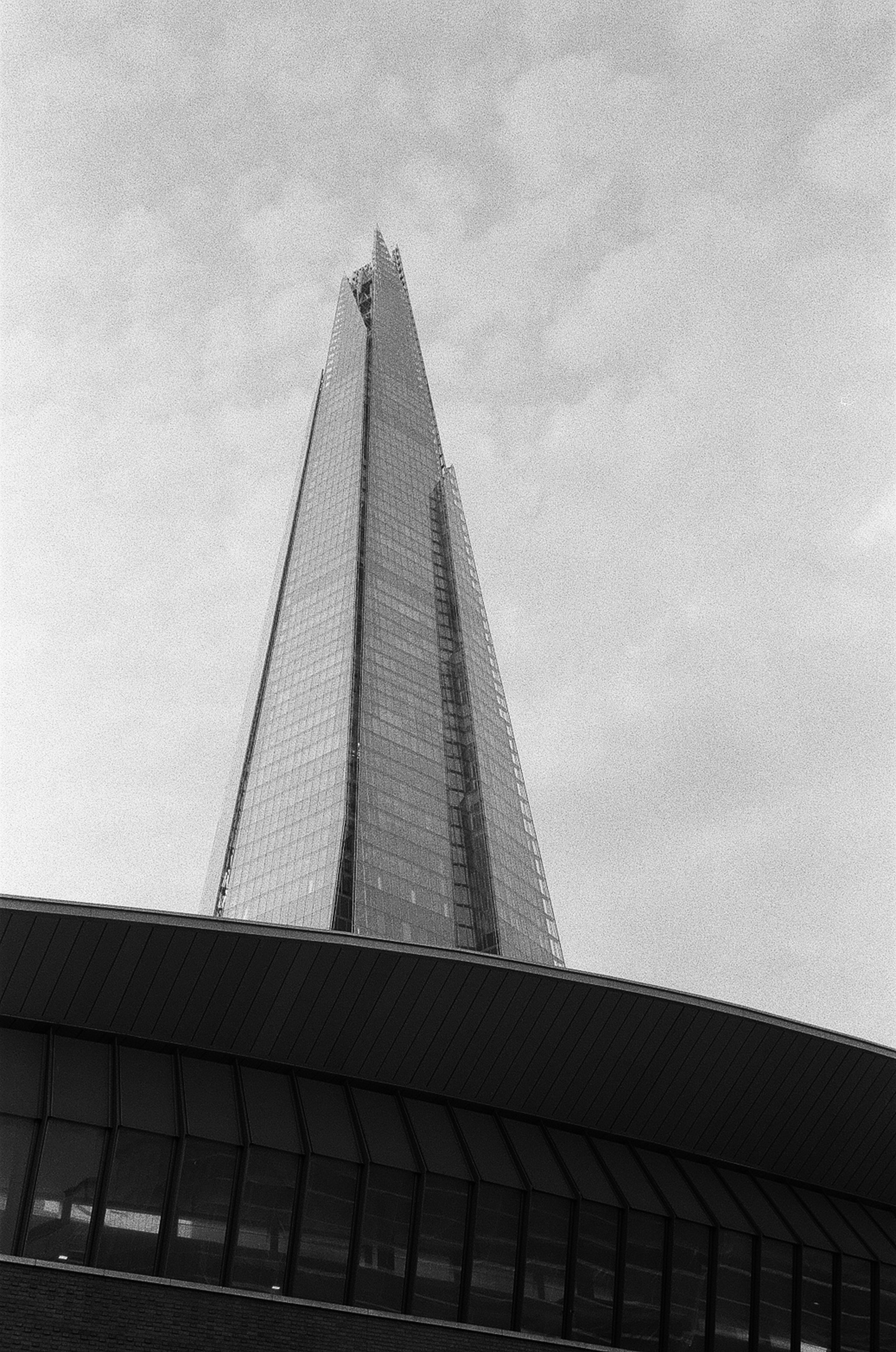a black and white photo of a very tall building