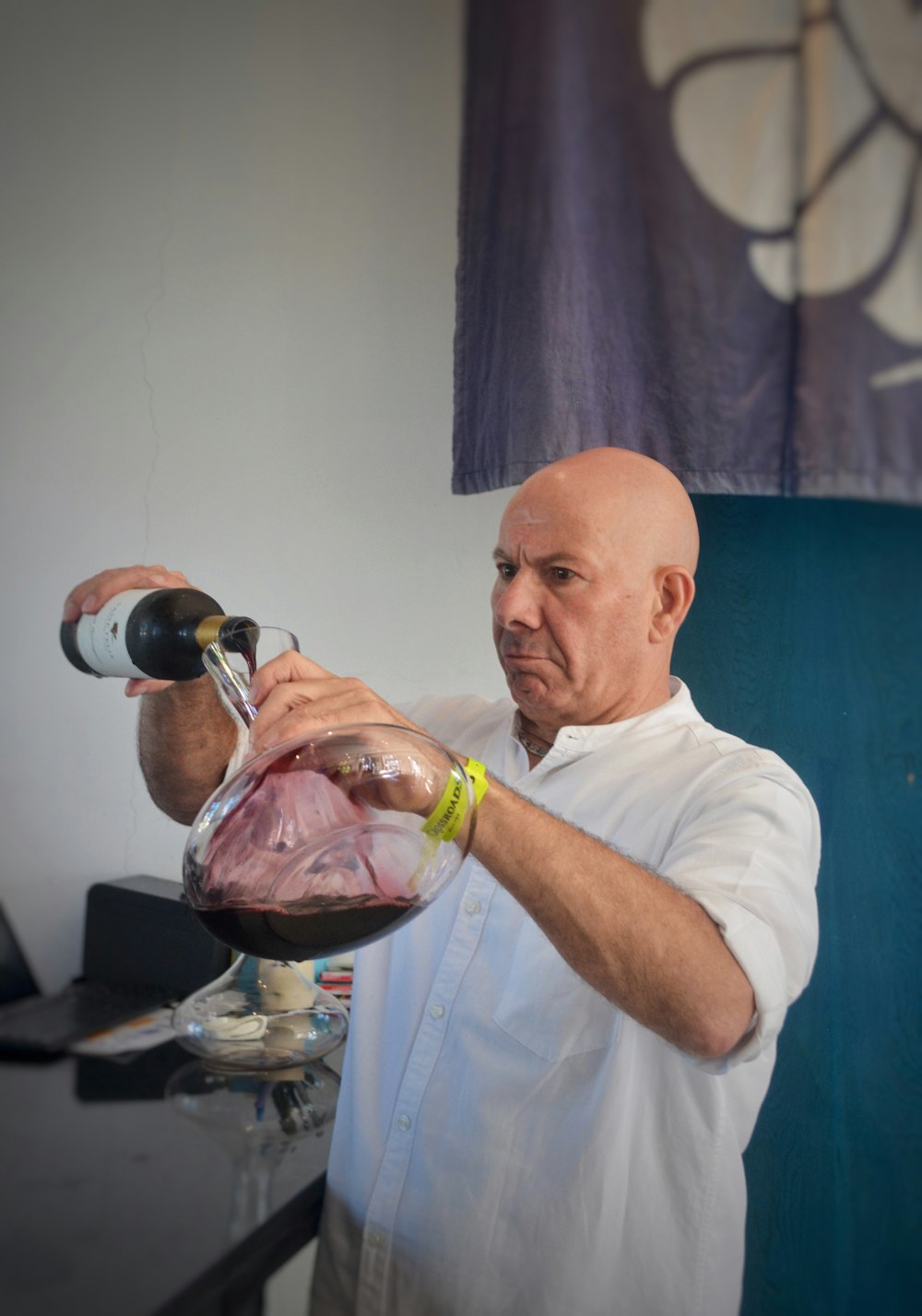 a man pouring a glass of wine into a bowl