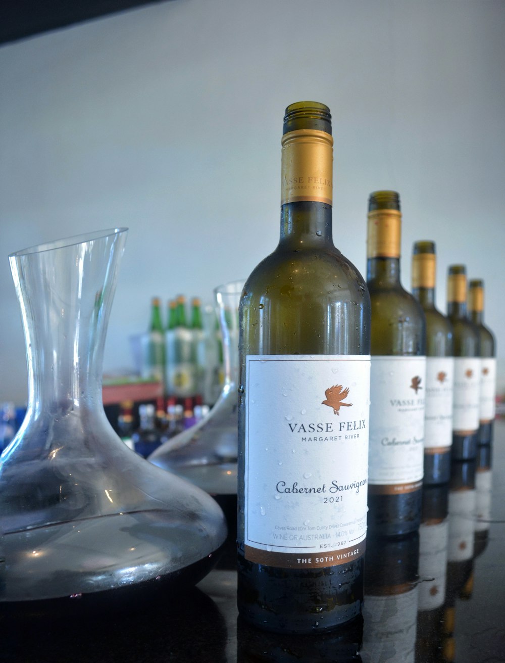 a row of wine bottles sitting on top of a table