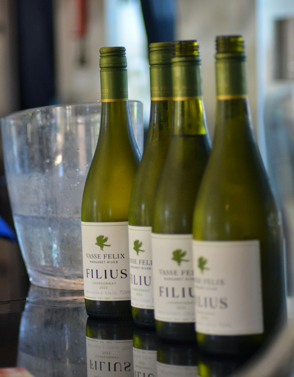 three bottles of wine are sitting on a table