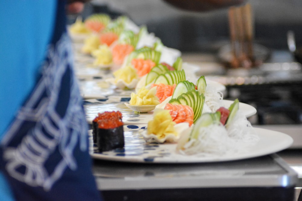 a row of sushi rolls on a plate