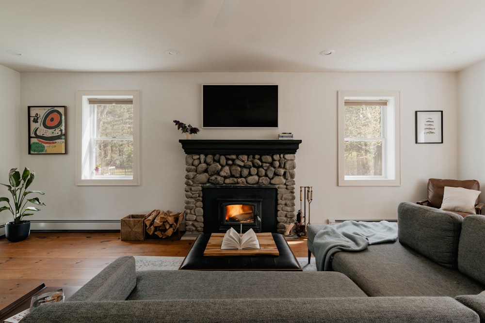 a living room with a fire place and couches