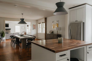 a kitchen with a table and a refrigerator