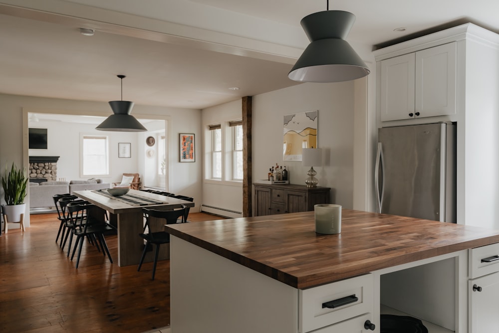 a kitchen with a table and a refrigerator