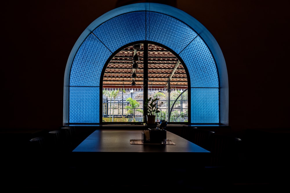 a large arched window in a dark room