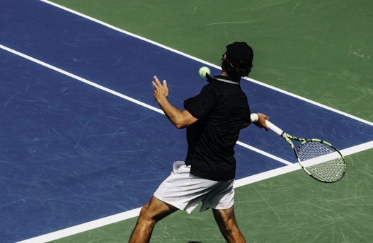 a man holding a tennis racquet on a tennis court