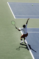 a man swinging a tennis racquet on a tennis court