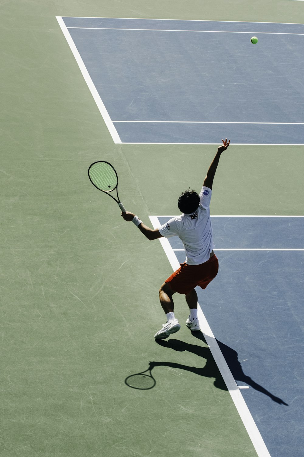 a man swinging a tennis racquet on a tennis court