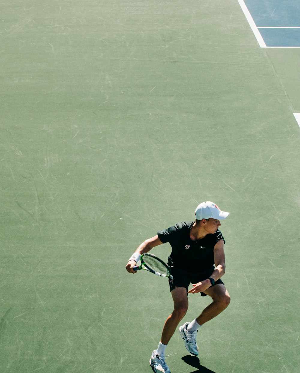 a woman holding a tennis racquet on a tennis court