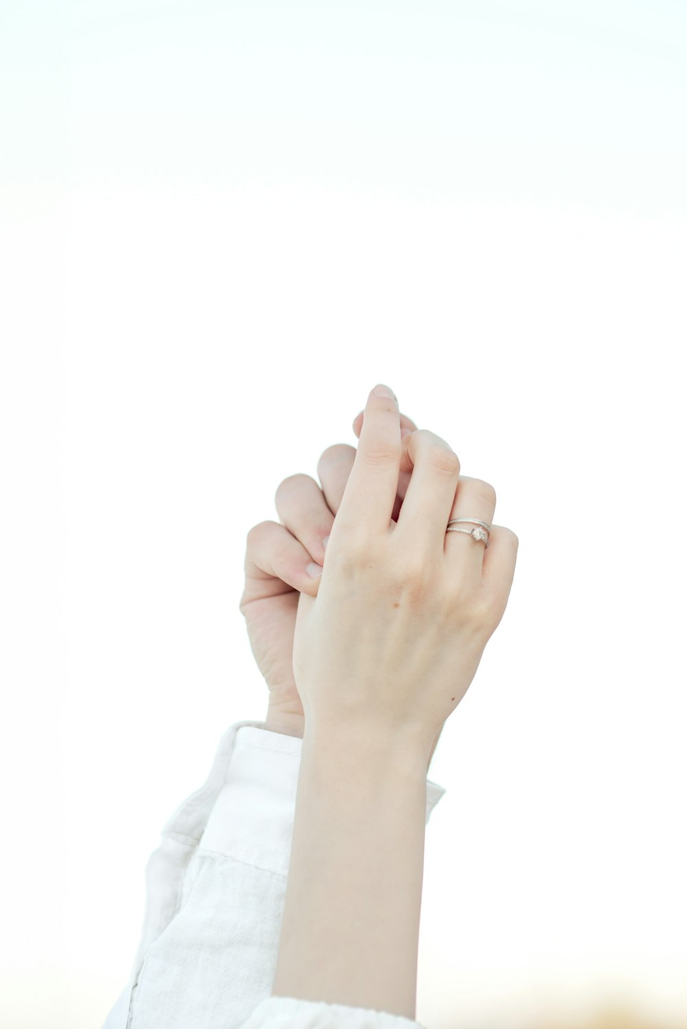 a woman holding her hand up to the sky