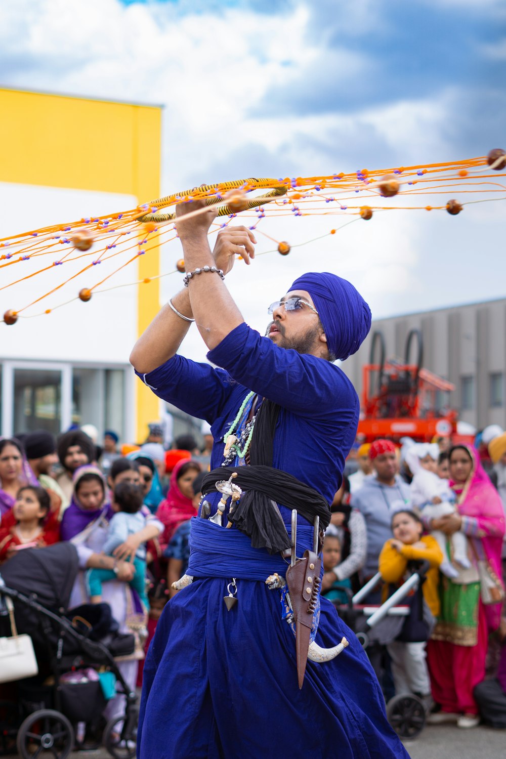 a man in a blue turban performing a dance