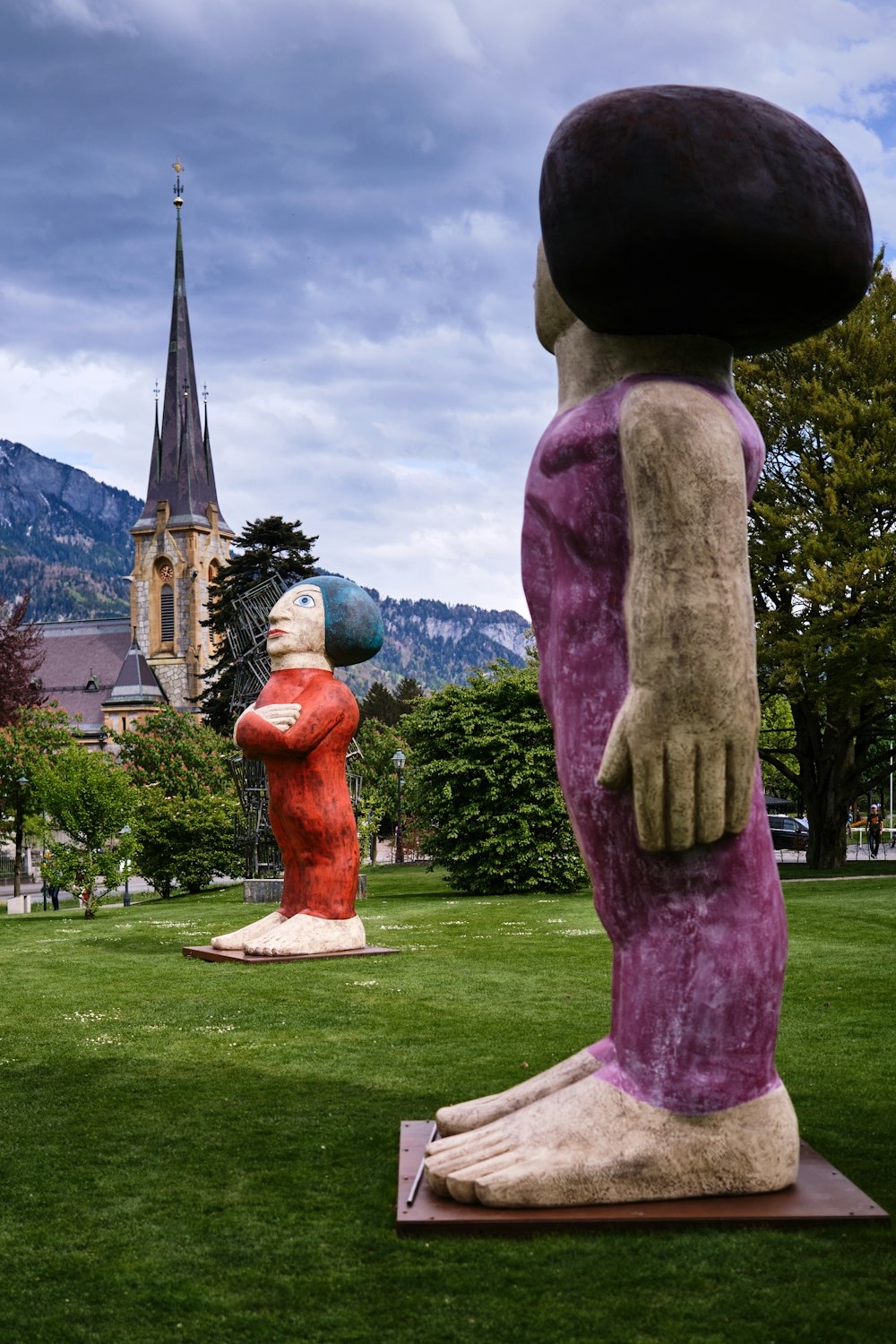 a couple of large statues in the grass