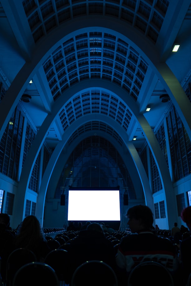 a group of people watching a movie in a darkened room