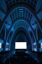 an empty auditorium with a large screen in the center
