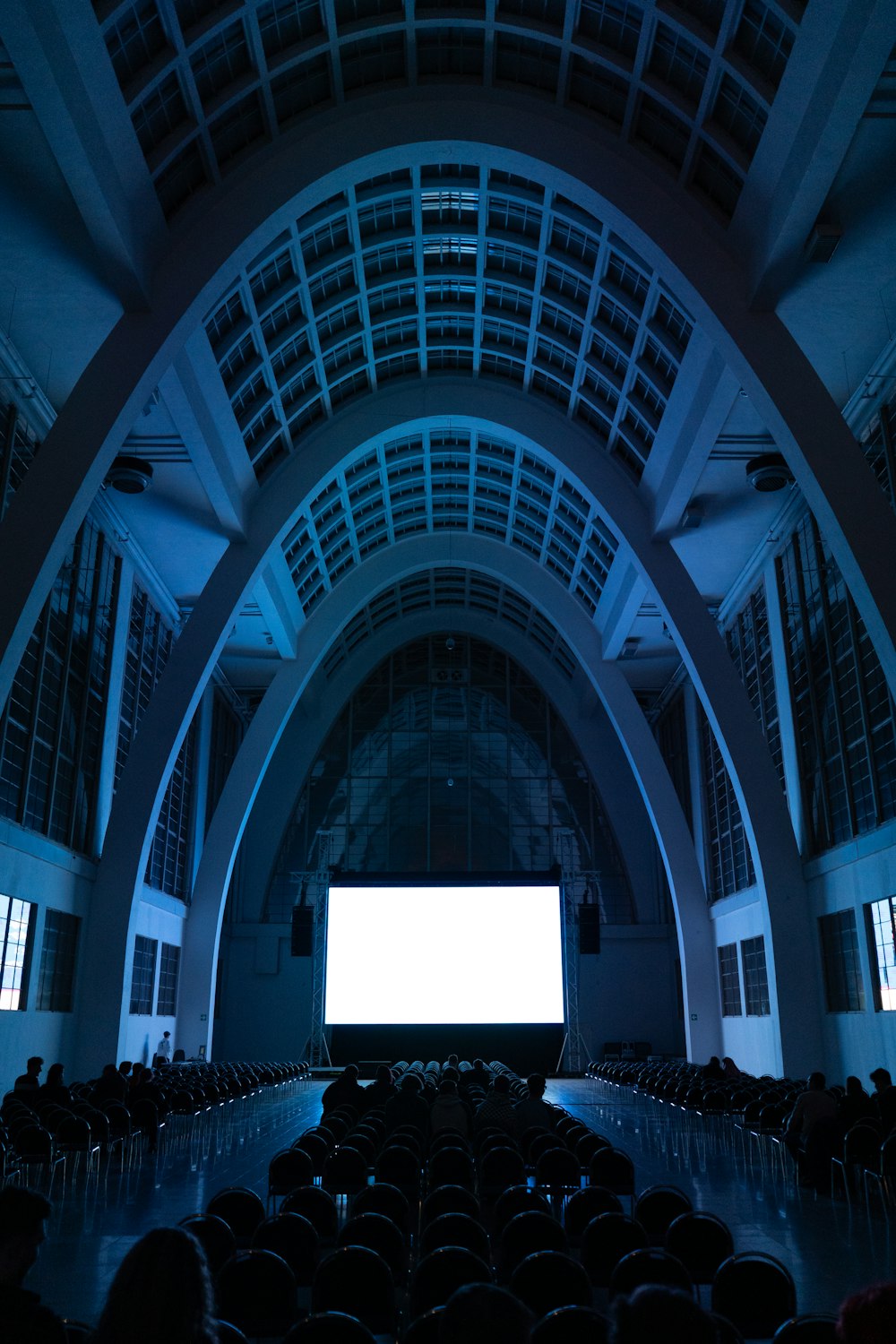 an empty auditorium with a large screen in the center