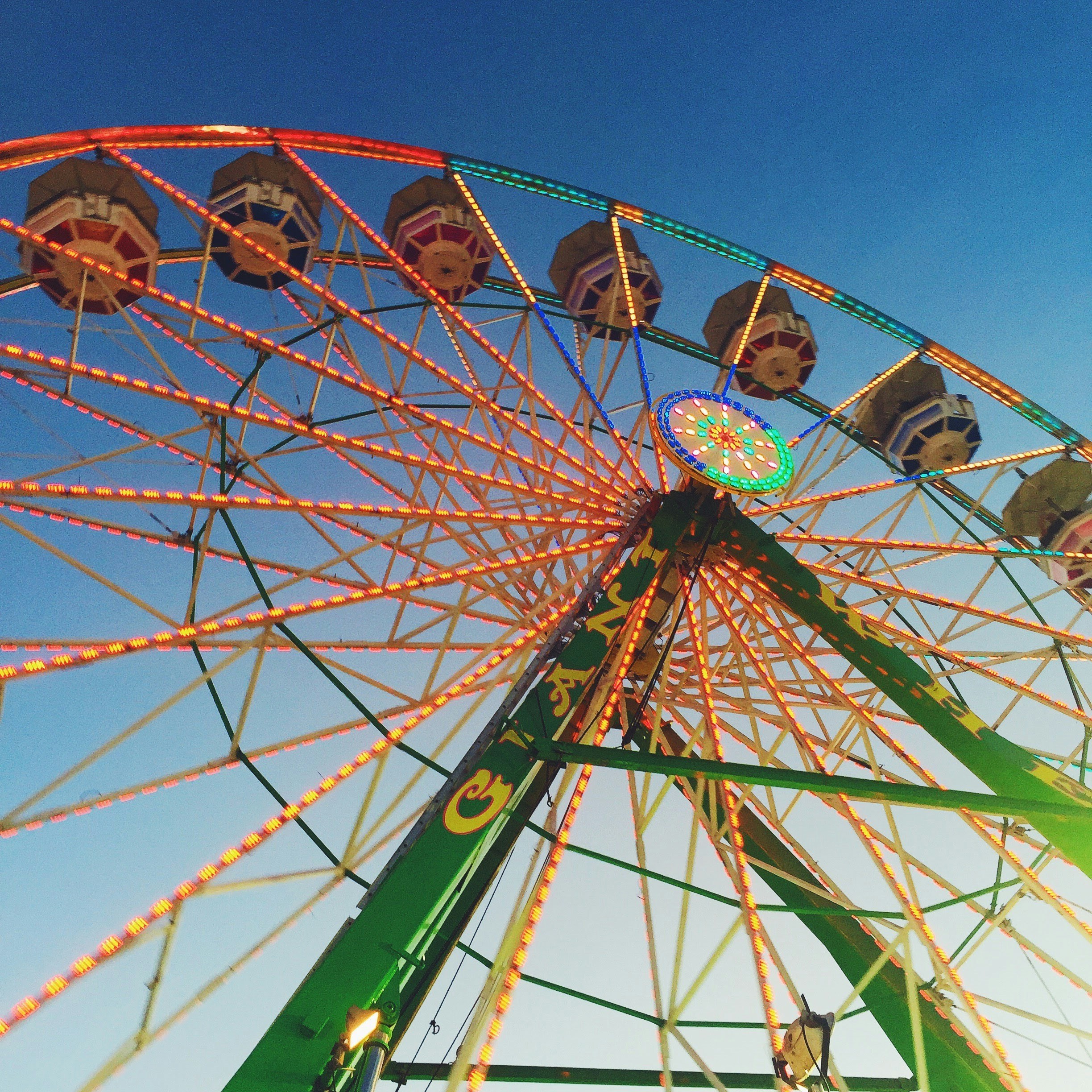 a ferris wheel is shown against a blue sky