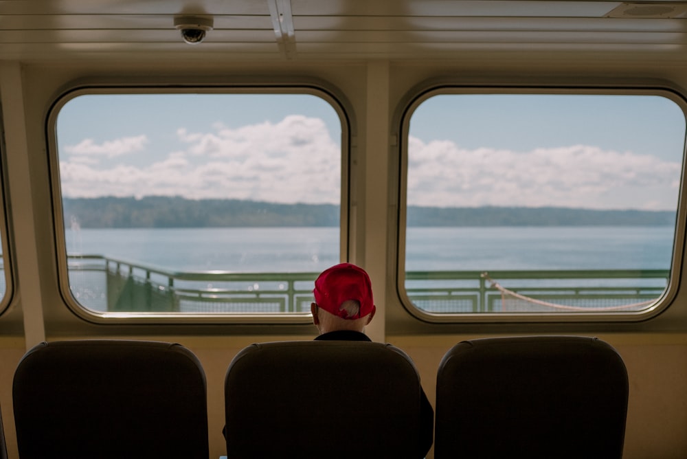 a person wearing a red hat sitting on a boat