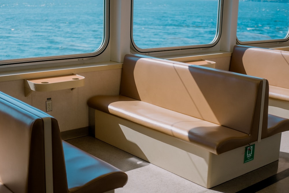 a row of seats sitting on top of a train next to a window