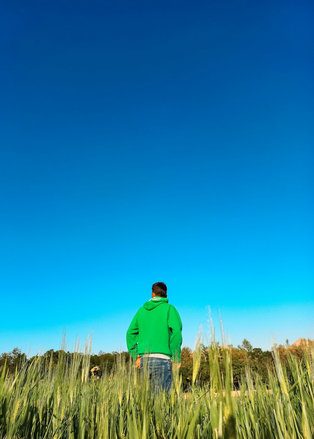 a man standing in a field of tall grass