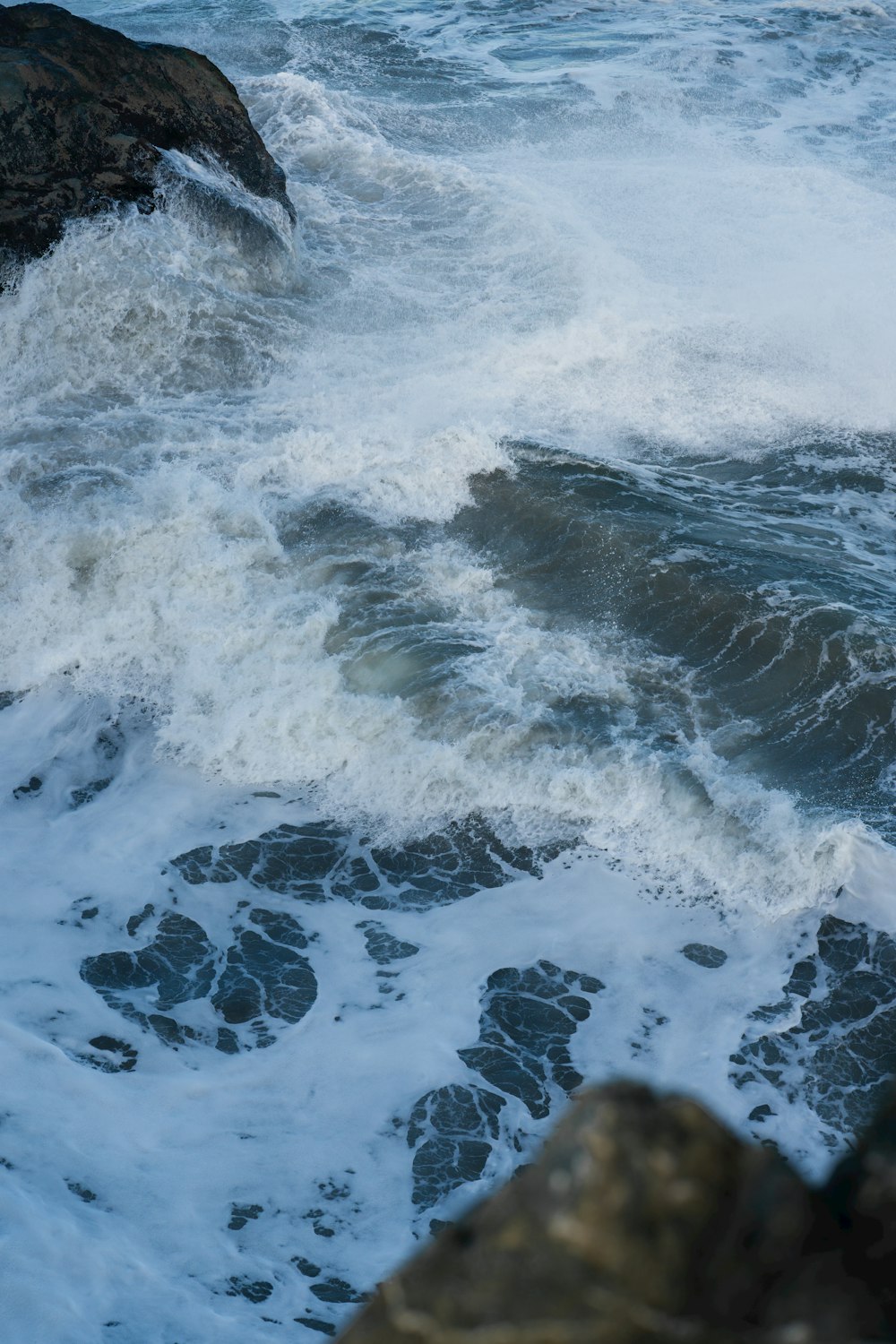 a large body of water next to a rocky shore