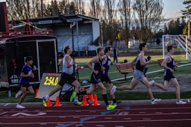 a group of people running on a track