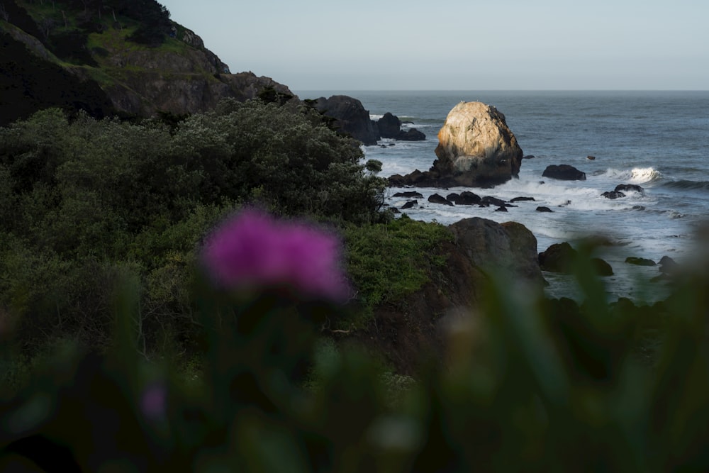 a large rock sticking out of the ocean