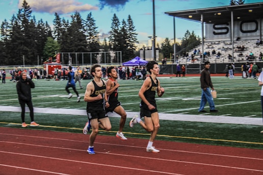 a group of men running on a track