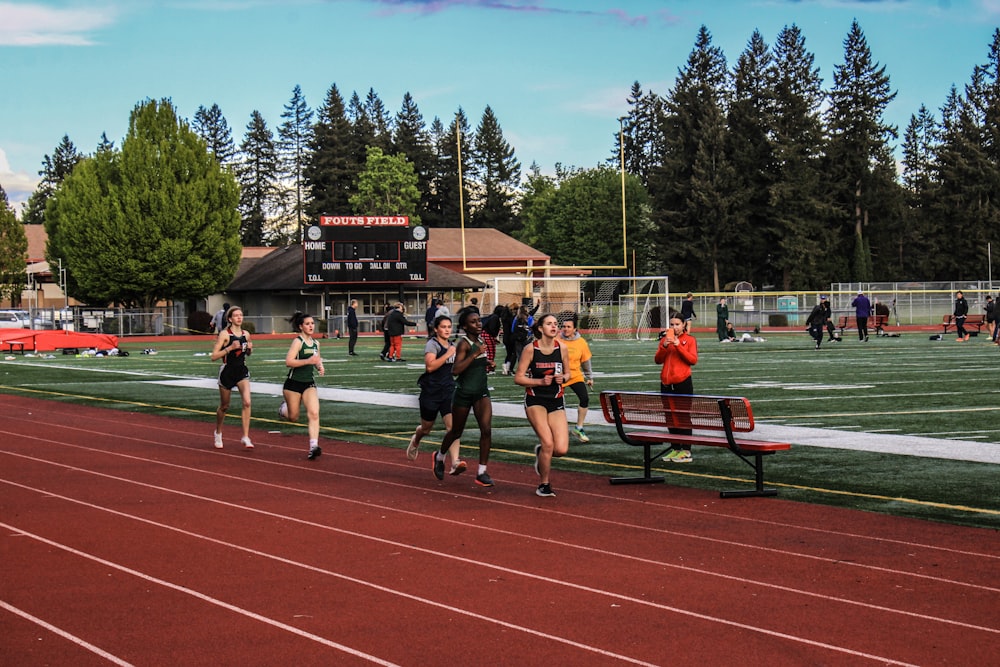 a group of people running on a track