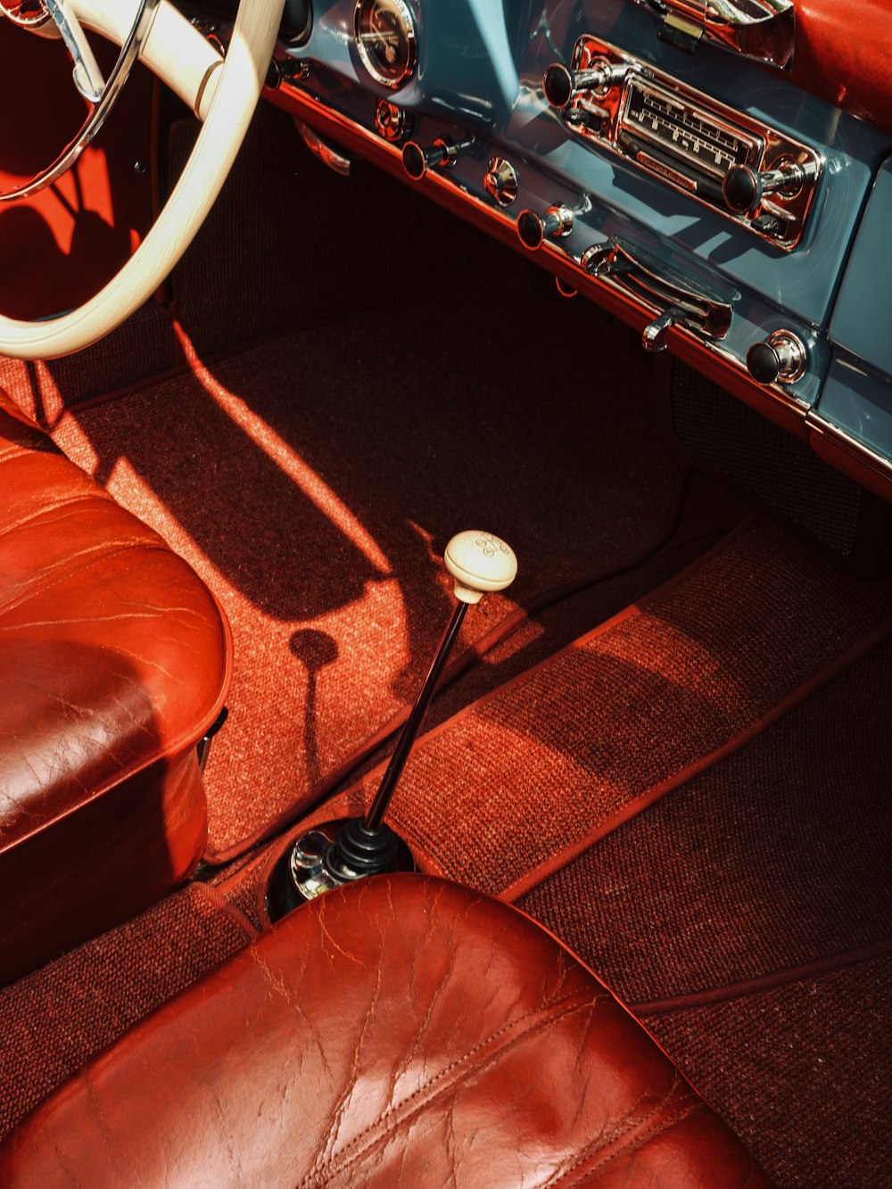the interior of a classic car with leather seats