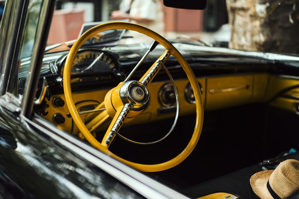 the interior of a car with a yellow steering wheel