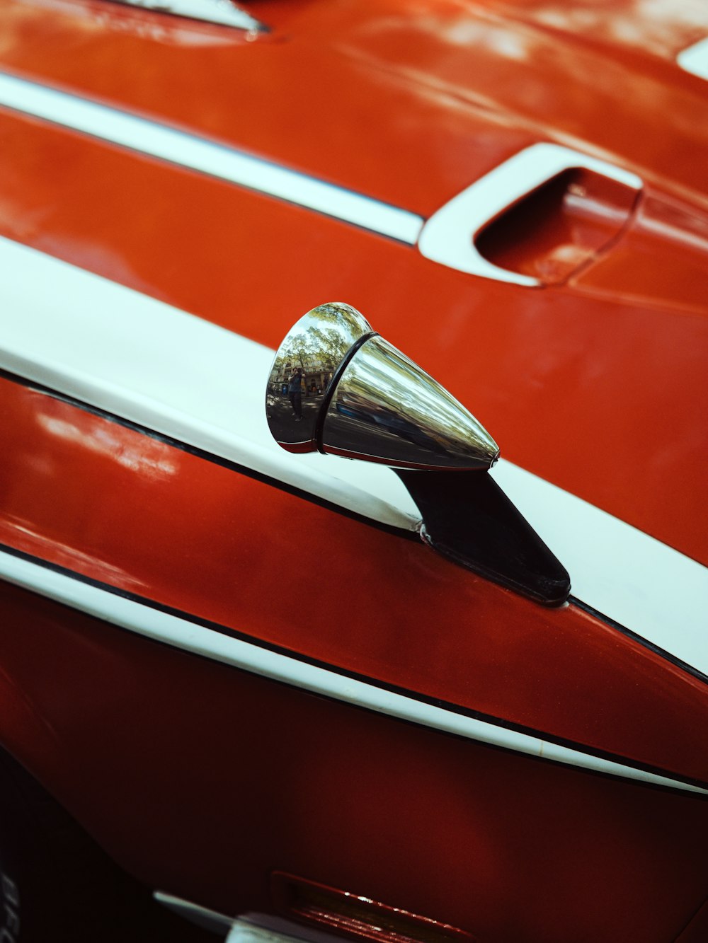 a close up of a red and white car door handle