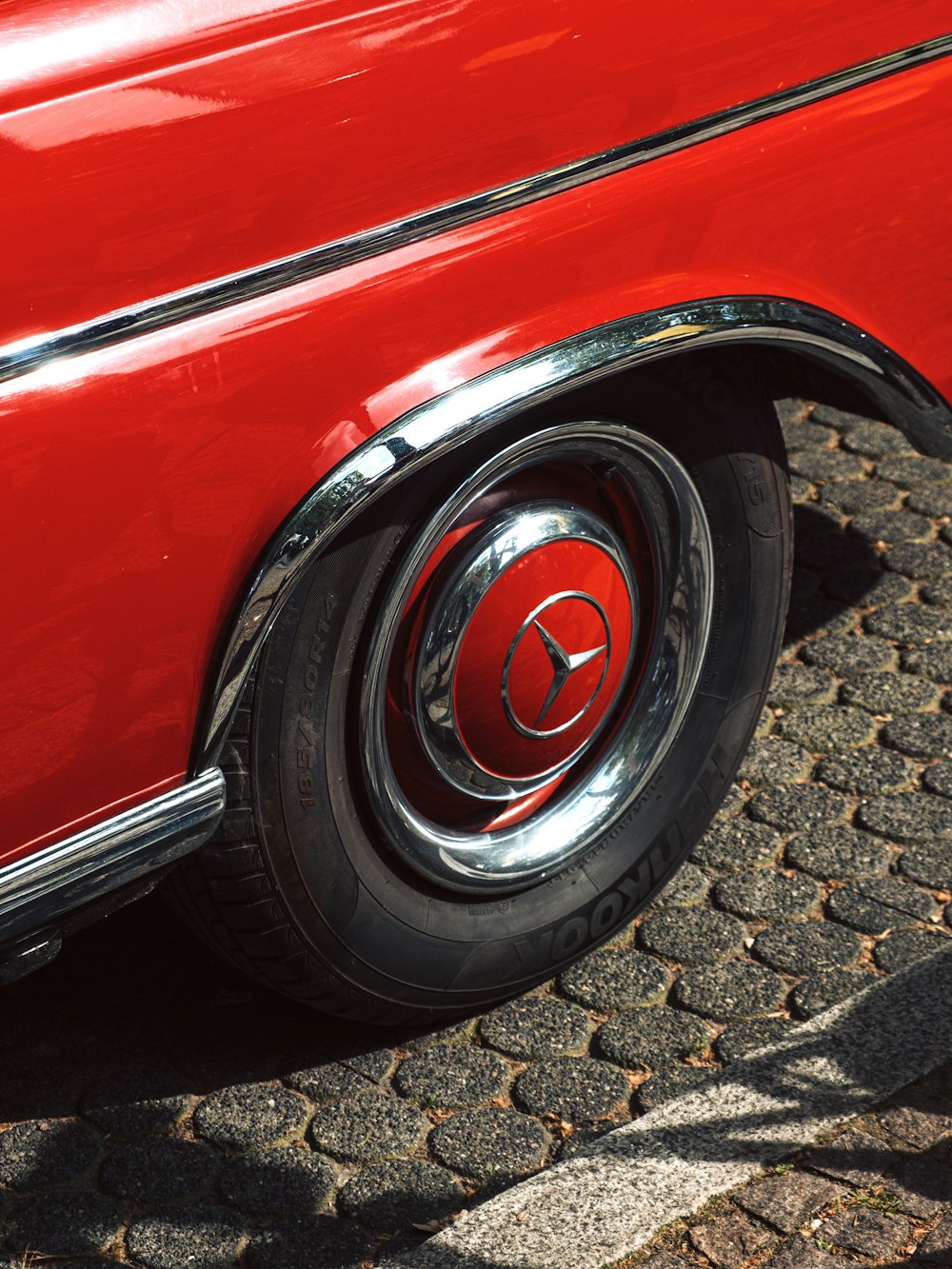 a close up of a red car tire