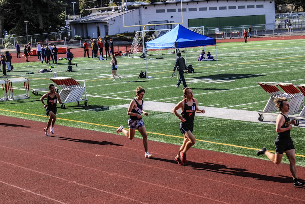 a group of girls running on a track