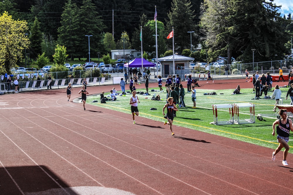 a group of people running on a track