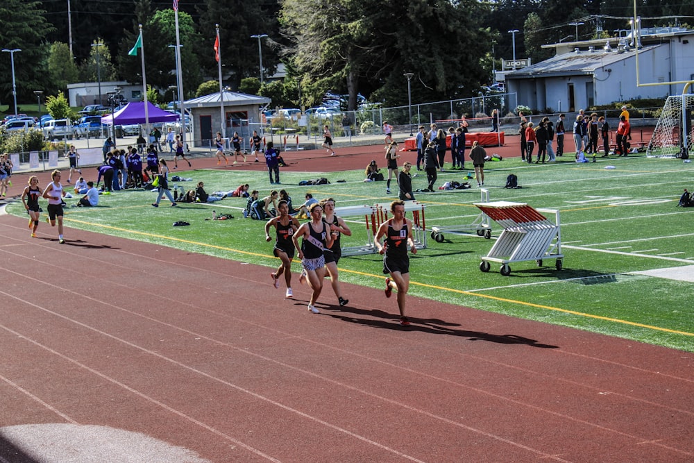 a group of people that are running on a track
