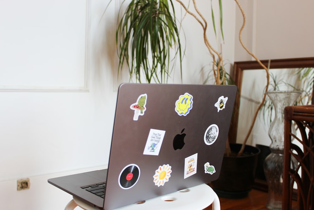 a laptop computer sitting on top of a white table