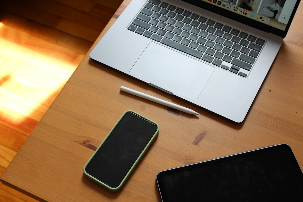 an open laptop computer sitting on top of a wooden desk