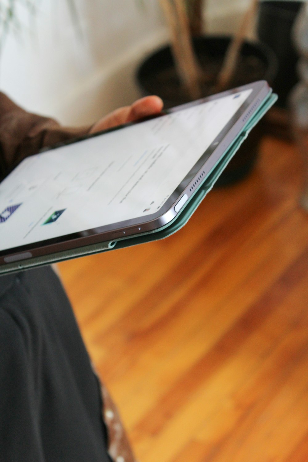 a person holding a tablet in their hand
