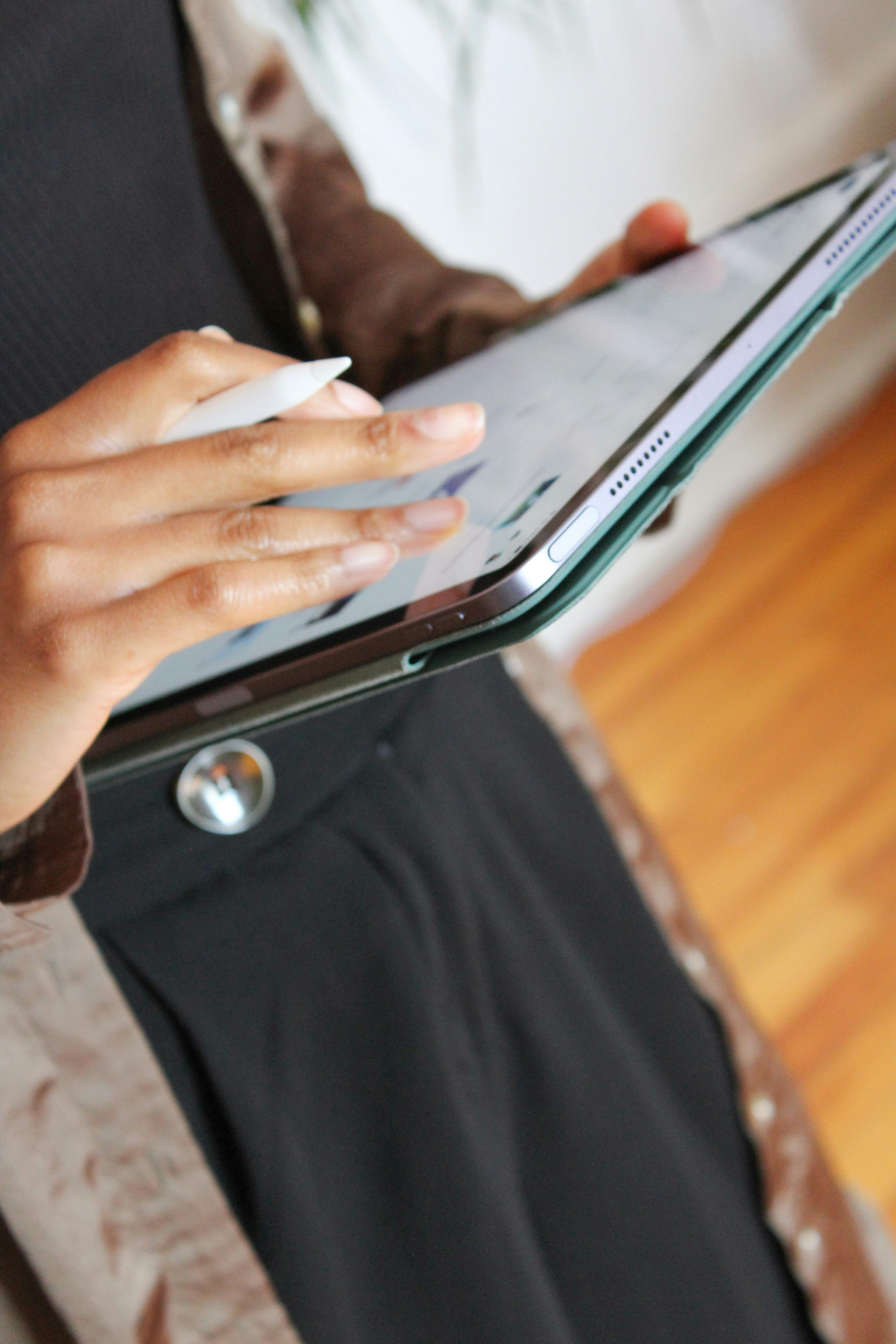 a person holding a tablet computer in their hands