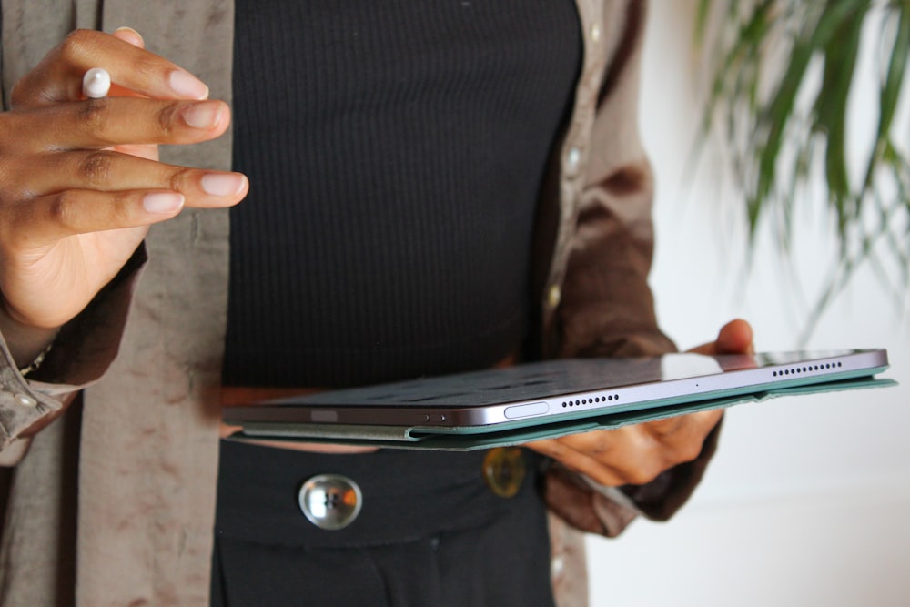 a woman holding a laptop computer in her hands