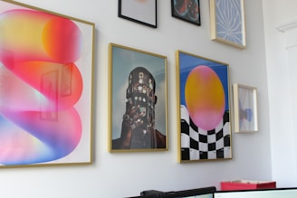 a wall with a bunch of paintings on it