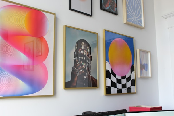 a wall with a bunch of paintings on it