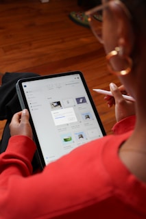 a woman sitting on the floor using a tablet